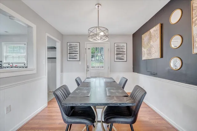 a view of a dining room with furniture window and wooden floor