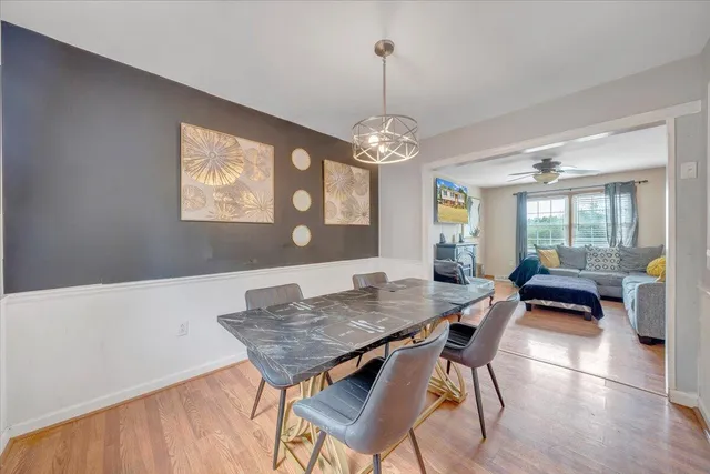 a view of a dining room with furniture wooden floor and chandelier