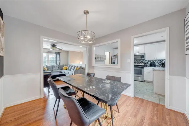 a view of a dining room with furniture and wooden floor