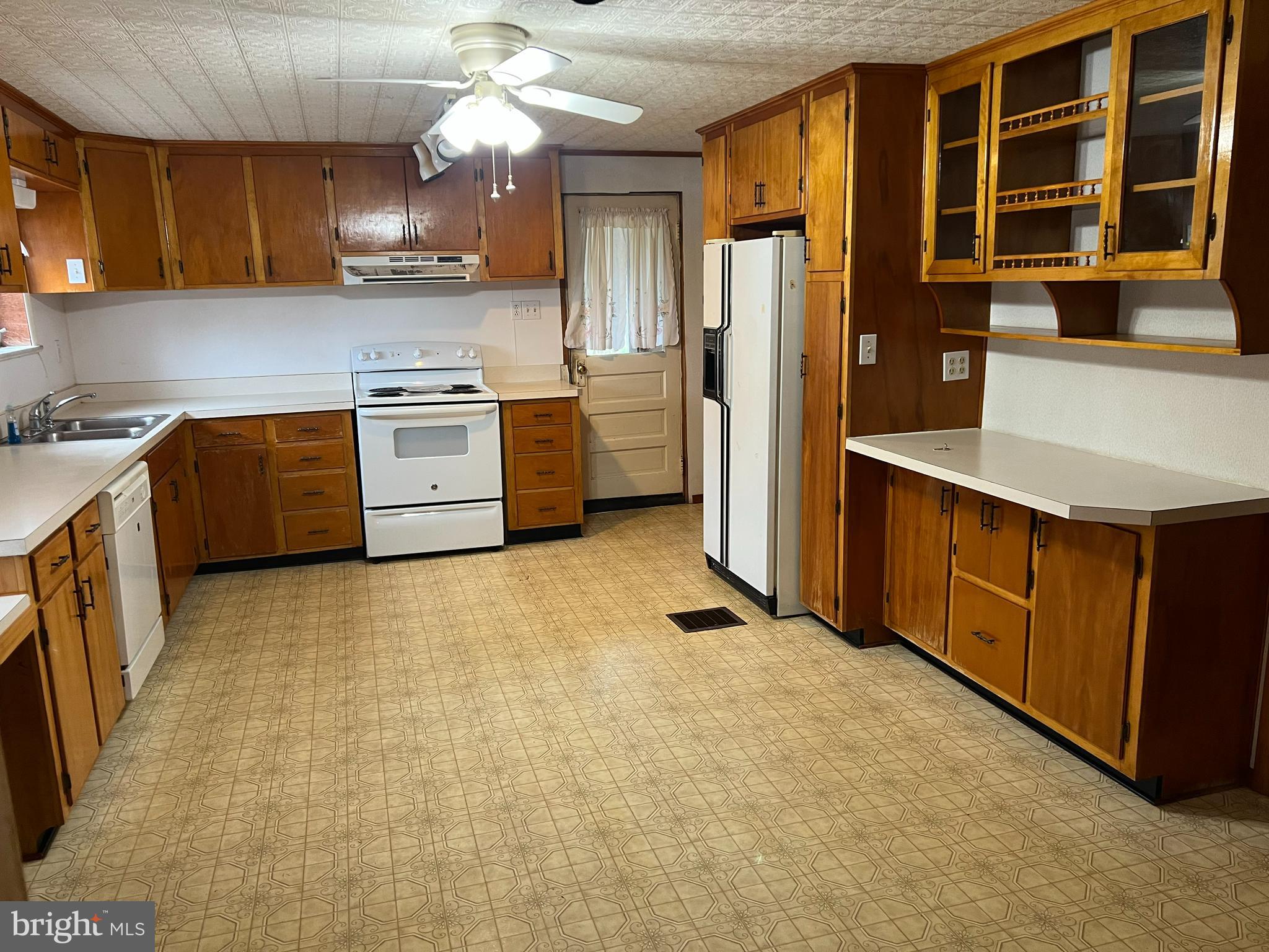 25447 Cascade Road Cascade, MD 21719 - Photo 7 of 22 a kitchen with stainless steel appliances granite countertop a stove a refrigerator a sink dishwasher and white cabinets with wooden floor