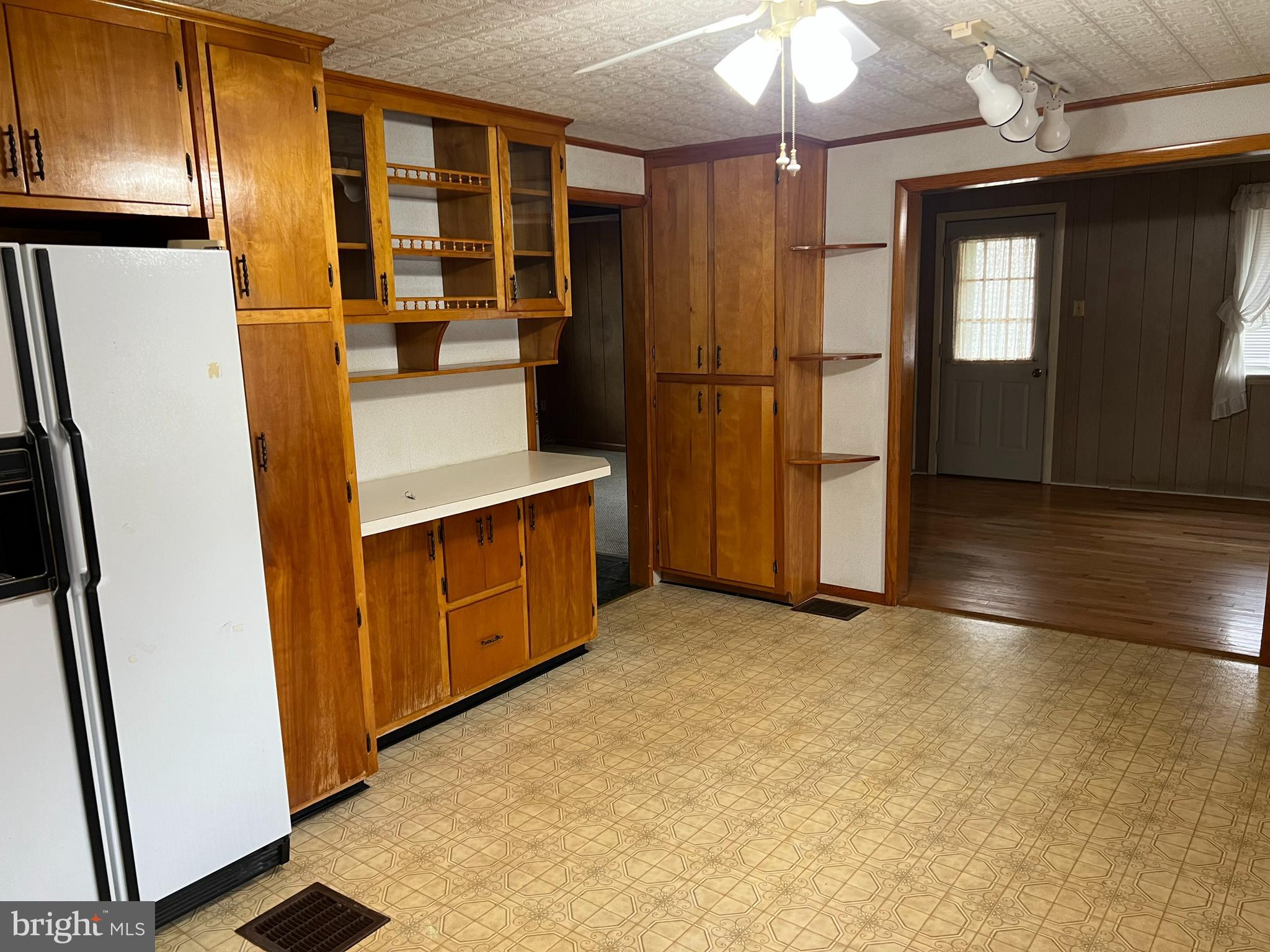25447 Cascade Road Cascade, MD 21719 - Photo 10 of 22 a view of a kitchen with a refrigerator a stove top oven cabinets and a refrigerator