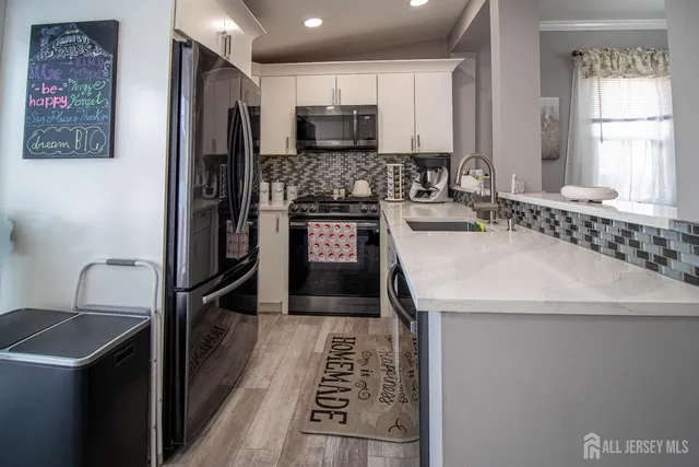 a kitchen with a refrigerator sink and stove