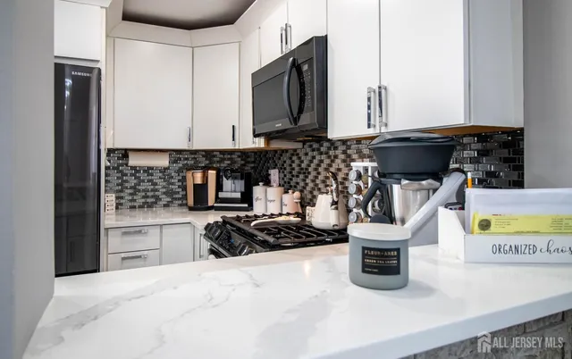 a kitchen with a sink a stove and cabinets