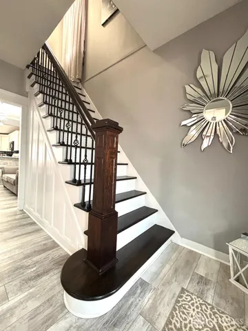 a view of entryway and hall with wooden floor