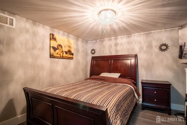 a bedroom with a bed and a chandelier