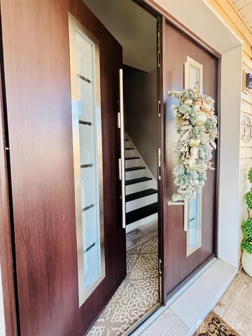 a view of a hallway with wooden floor and entryway