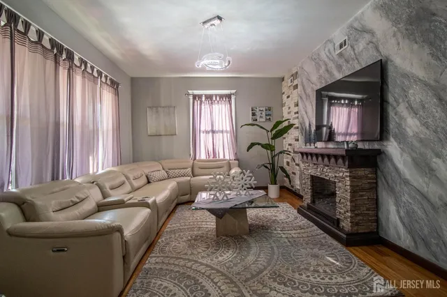 a living room with furniture a fireplace and a window