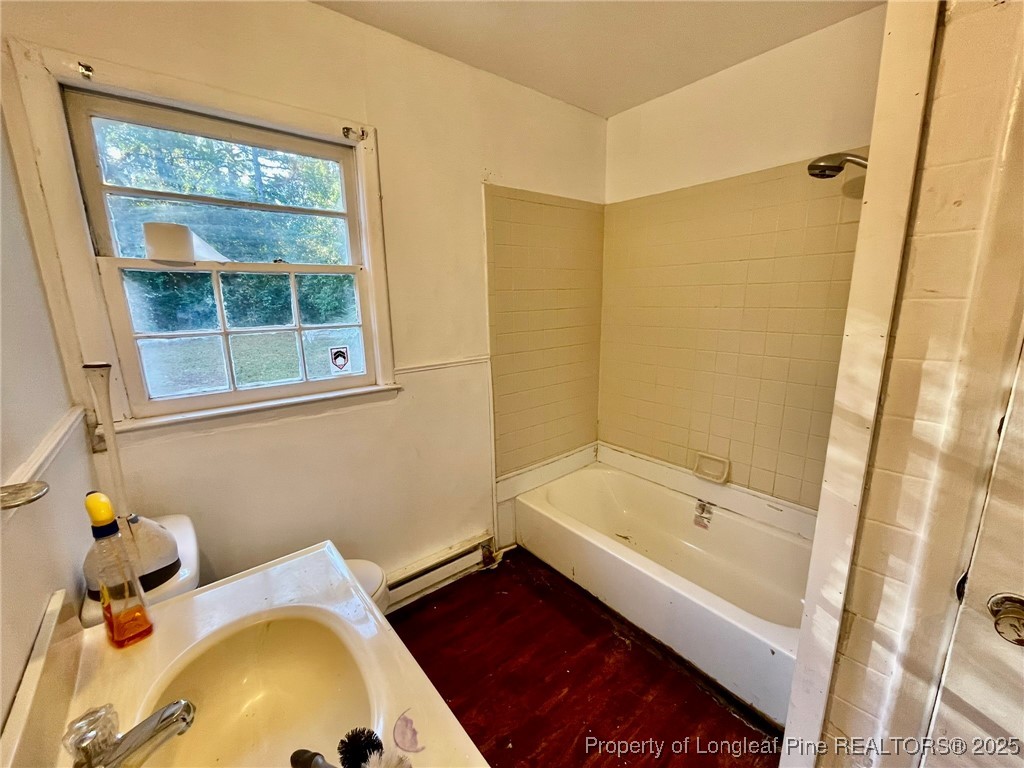 502 Spring Avenue Spring Lake, NC 28390 - Photo 12 of 20 a bathroom with a tub and a sink