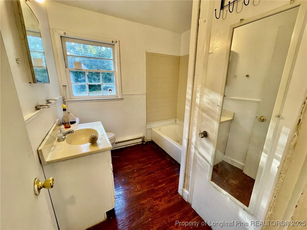 502 Spring Avenue Spring Lake, NC 28390 - Photo 13 of 20 a bathroom with a sink and a mirror with bathtub