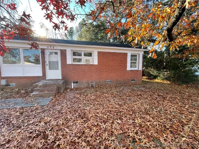 front view of house with a trees