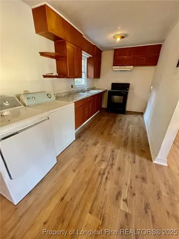 a kitchen with a sink window and stainless steel appliances