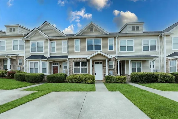 a front view of a house with a yard