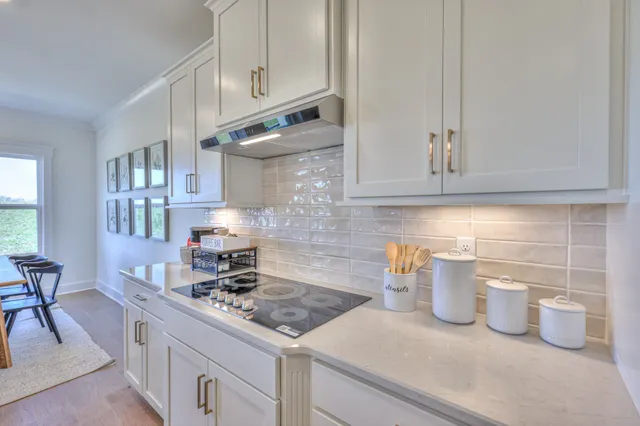 a kitchen with a dining table chairs and view kitchen