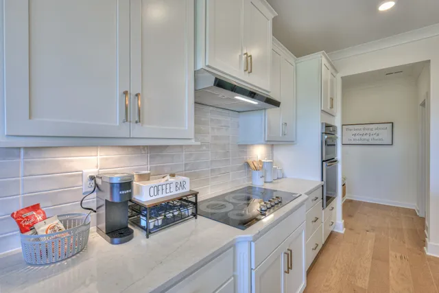 a living room with furniture a fireplace and wall paintings