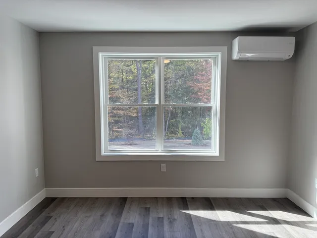 an empty room with wooden floor and closet