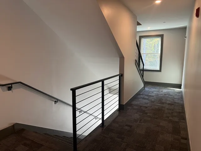 a view of a house with wooden fence next to a house