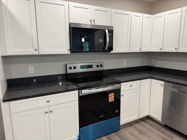 a kitchen with white cabinets and a sink
