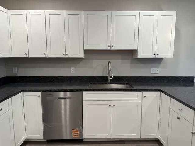 a kitchen with a sink and chandelier