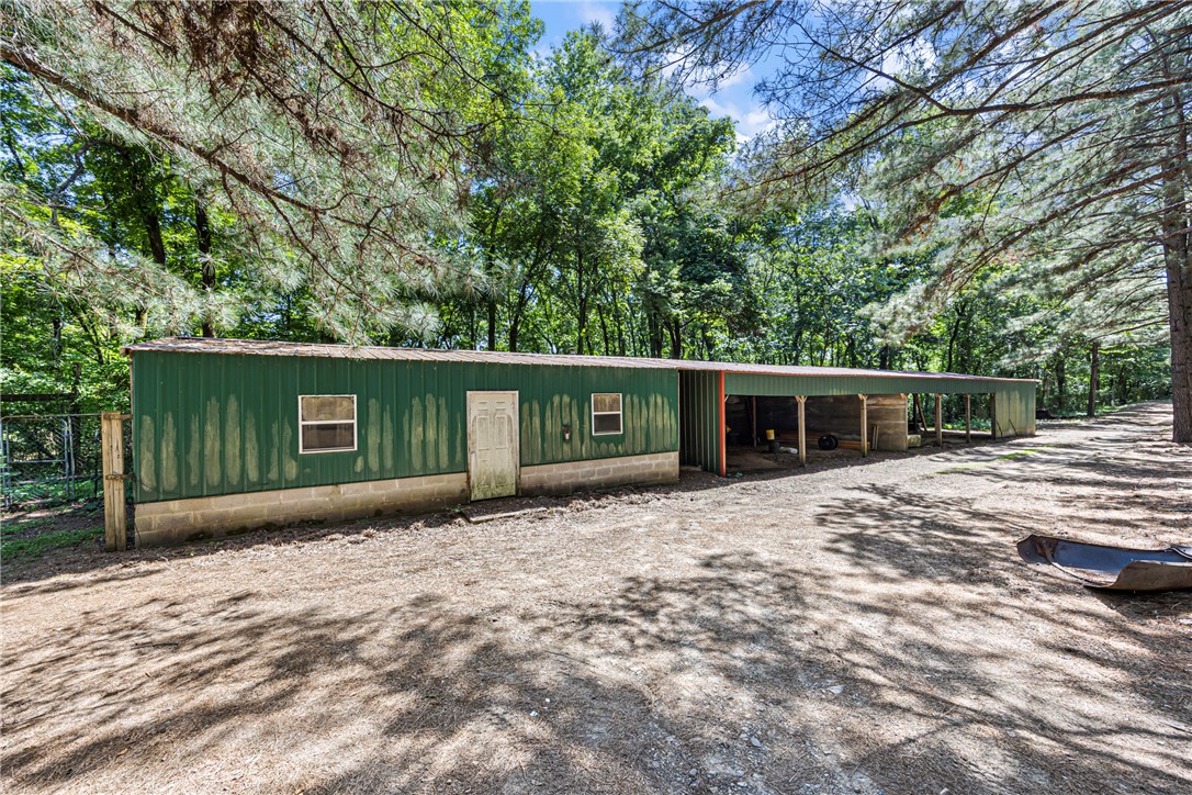 655 Charton Road Morrilton, AR 72110 - Photo 45 of 49 Metal-sided barn featuring a covered lean-to and visible windows