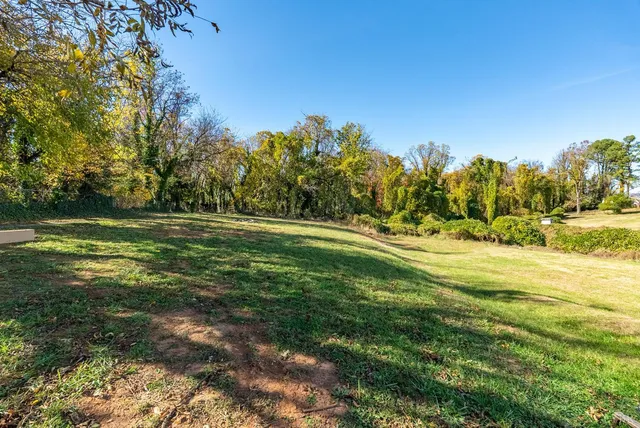an aerial view of residential houses with city view