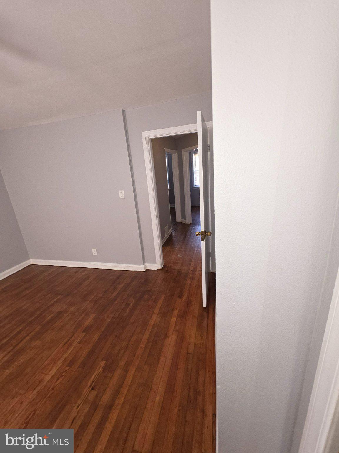 4404 Mountview Road Baltimore, MD 21229 - Photo 9 of 22 a view of a hallway with wooden floor