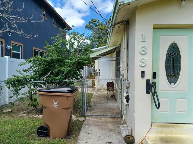 a backyard of a house with table and chairs