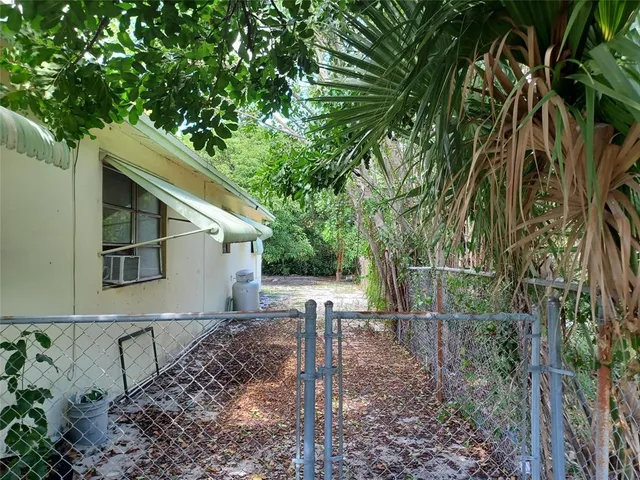 a view of a yard with wooden fence