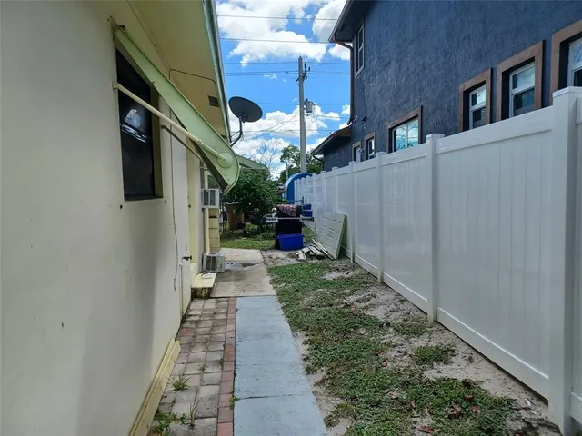 a backyard of a house with table and chairs