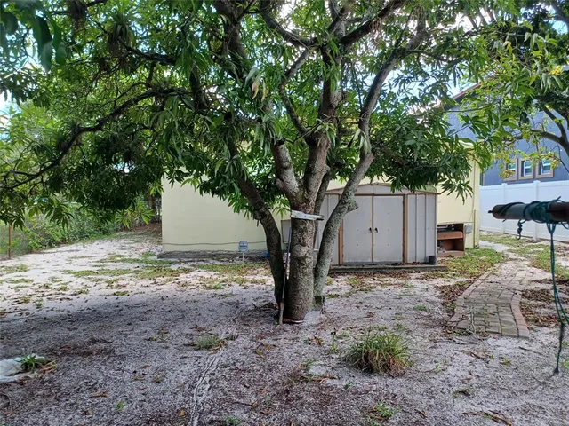 a kitchen with a refrigerator and a stove top oven