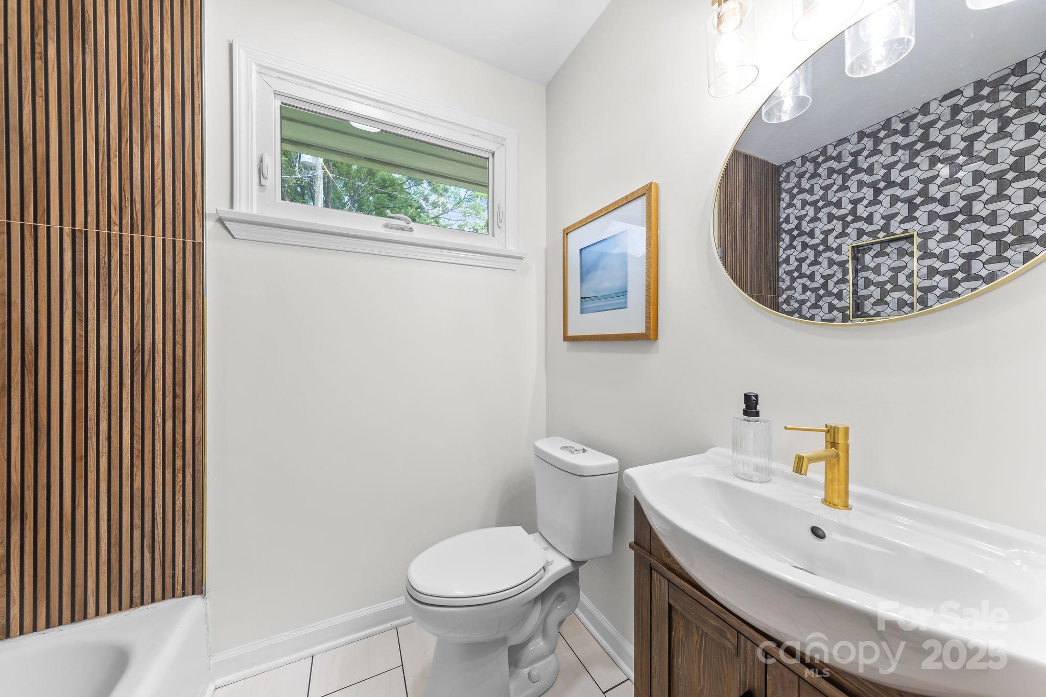 4226 Randolph Road Charlotte, NC 28211 - Photo 16 of 23 a bathroom with a toilet sink and mirror