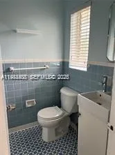 a bathroom with a toilet a sink and a shower