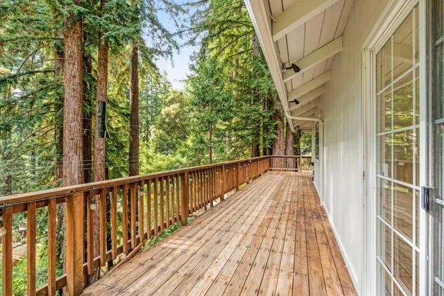 a view of a balcony with large trees