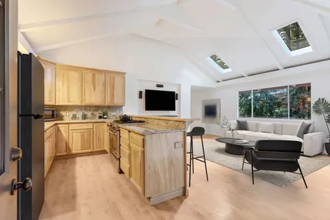 an empty room with windows fire place and a fireplace