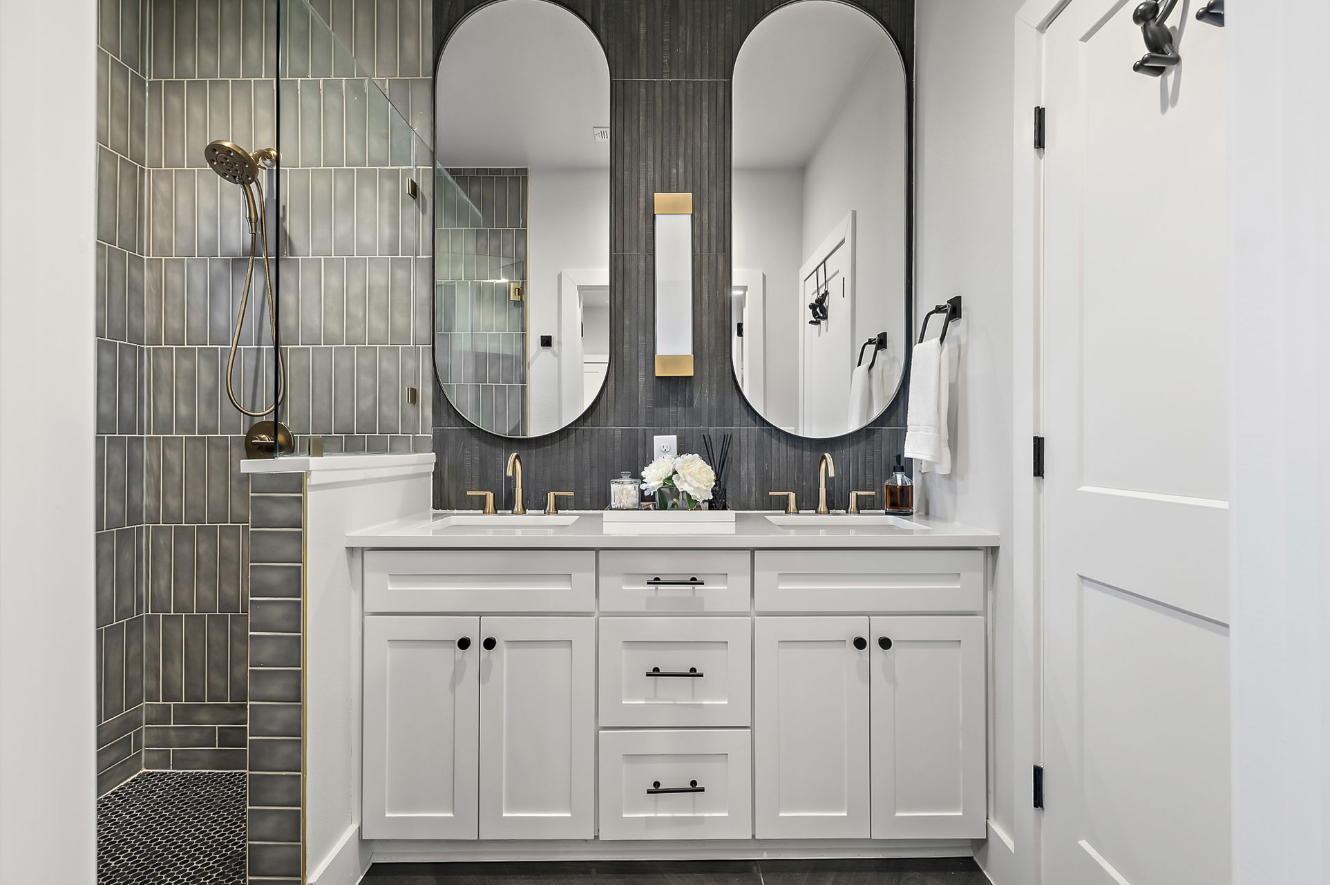 4607 Leslie Avenue, Unit A Austin, TX 78721 - Photo 11 of 20 The primary bathroom offers a dual vanity and contemporary vertical tiling