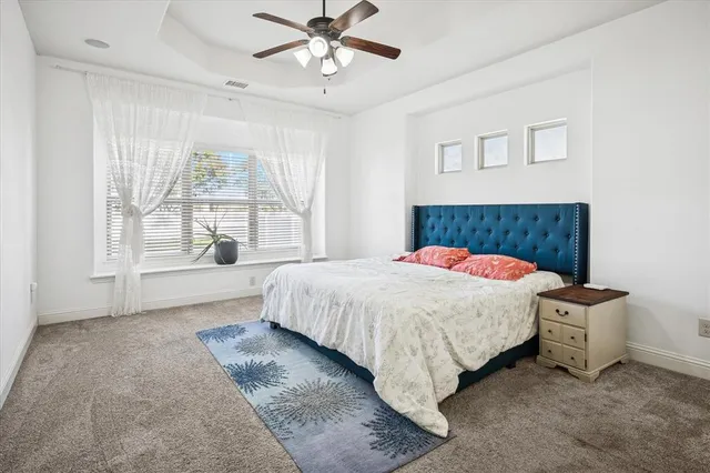 a spacious bedroom with a bed and a window