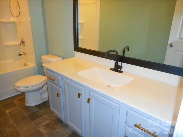 a bathroom with a toilet and bathtub