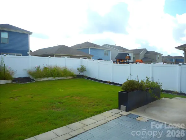 a view of a house with a yard and a sitting area