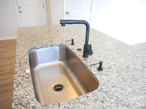 a kitchen with stainless steel appliances granite countertop a stove and a microwave