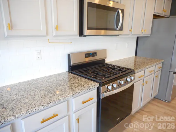 a kitchen with a refrigerator sink and microwave