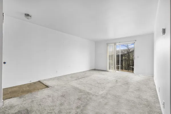 a view of an empty room with glass door