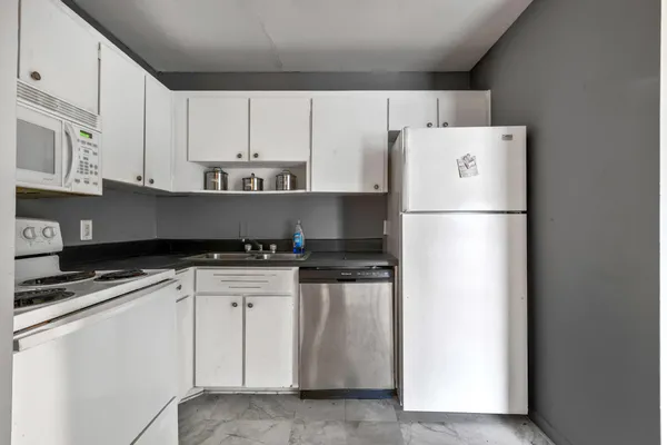 a white refrigerator freezer sitting in a kitchen