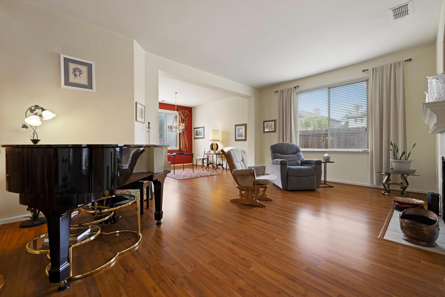4237 Blake Drive Modesto, CA 95356 - Photo 13 of 49 a living room with furniture a wooden floor and a large window