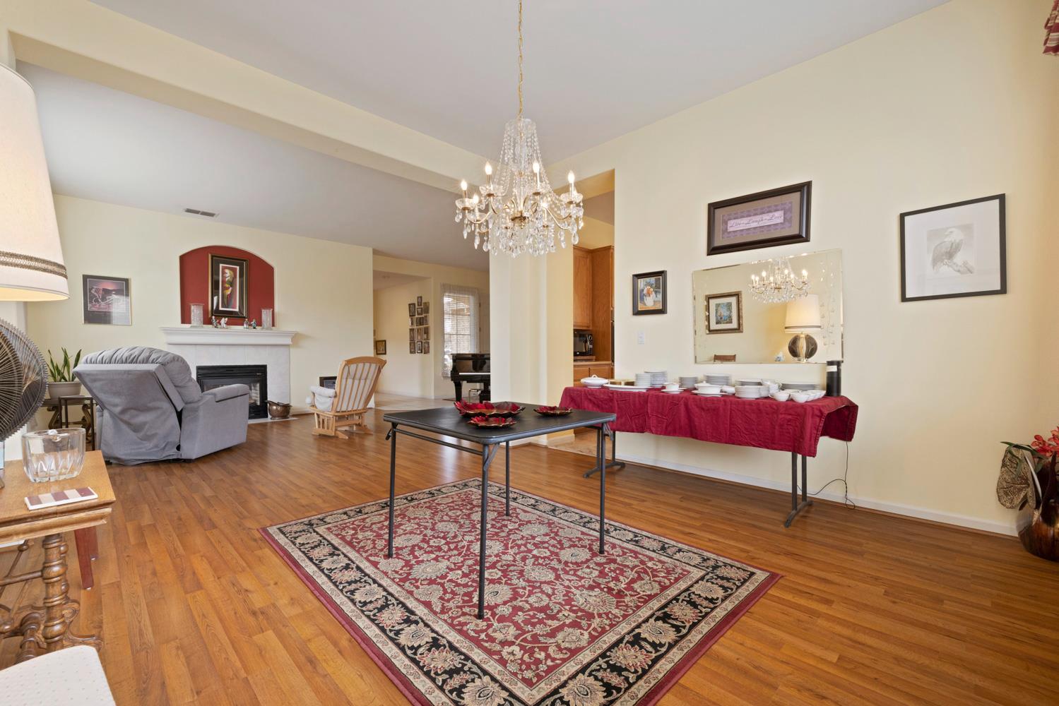 4237 Blake Drive Modesto, CA 95356 - Photo 17 of 49 a living room with furniture a rug and a chandelier