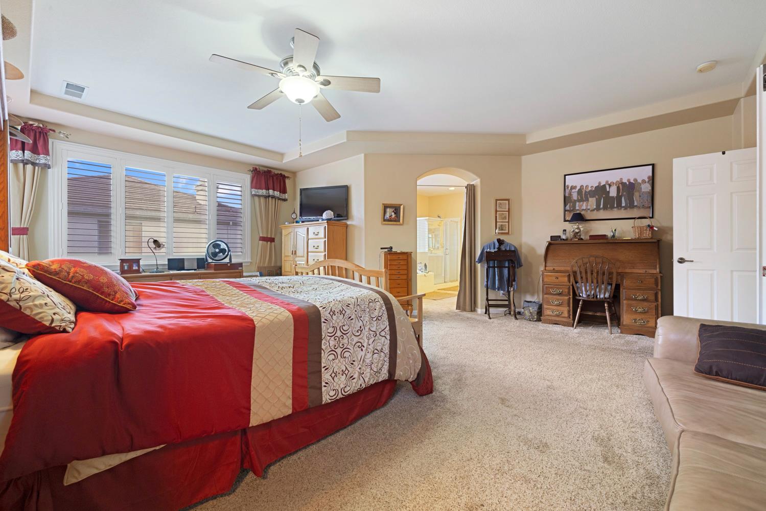 4237 Blake Drive Modesto, CA 95356 - Photo 40 of 49 a spacious bedroom with a bed and a fireplace