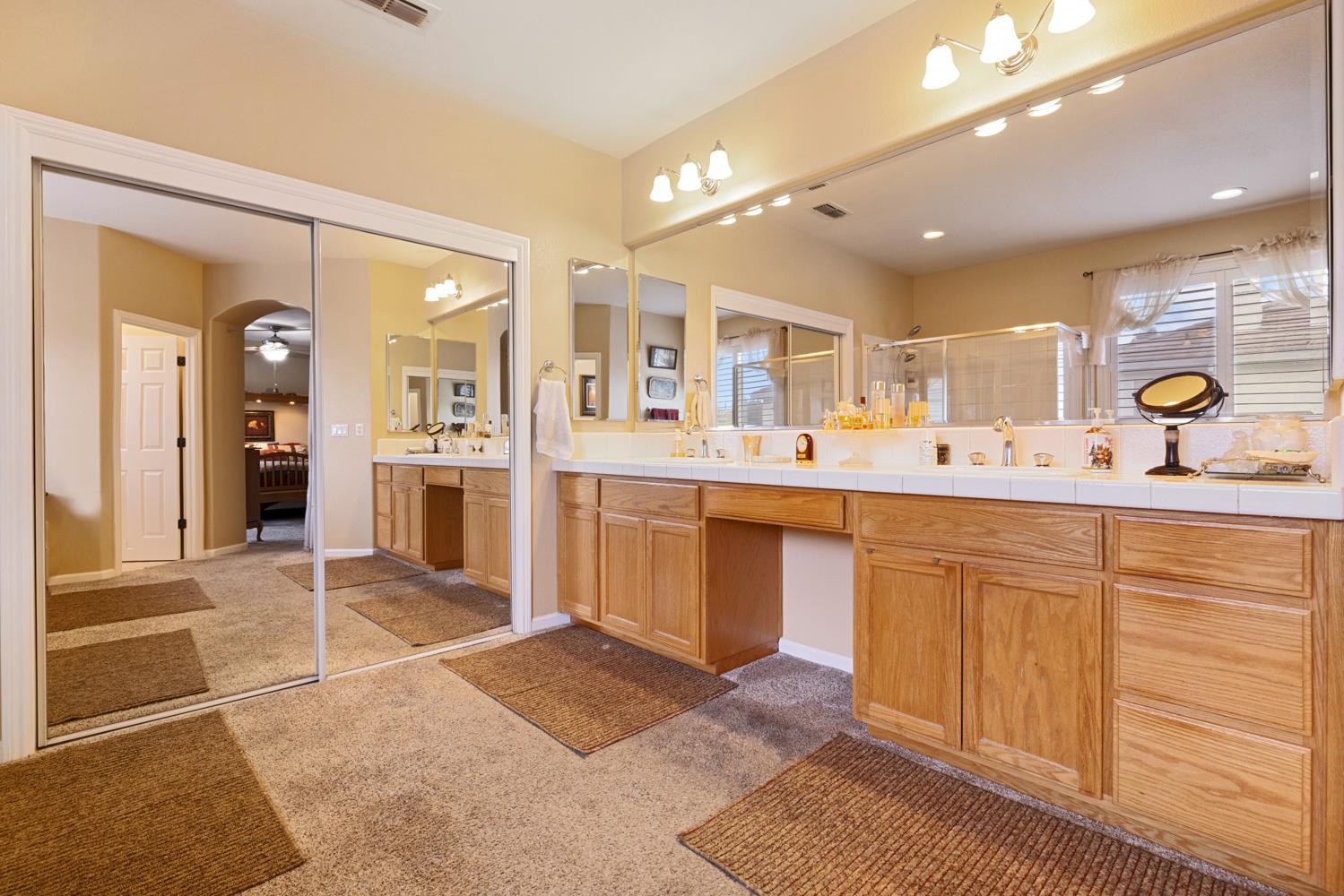4237 Blake Drive Modesto, CA 95356 - Photo 42 of 49 a spacious bathroom with a sink a mirror and shower