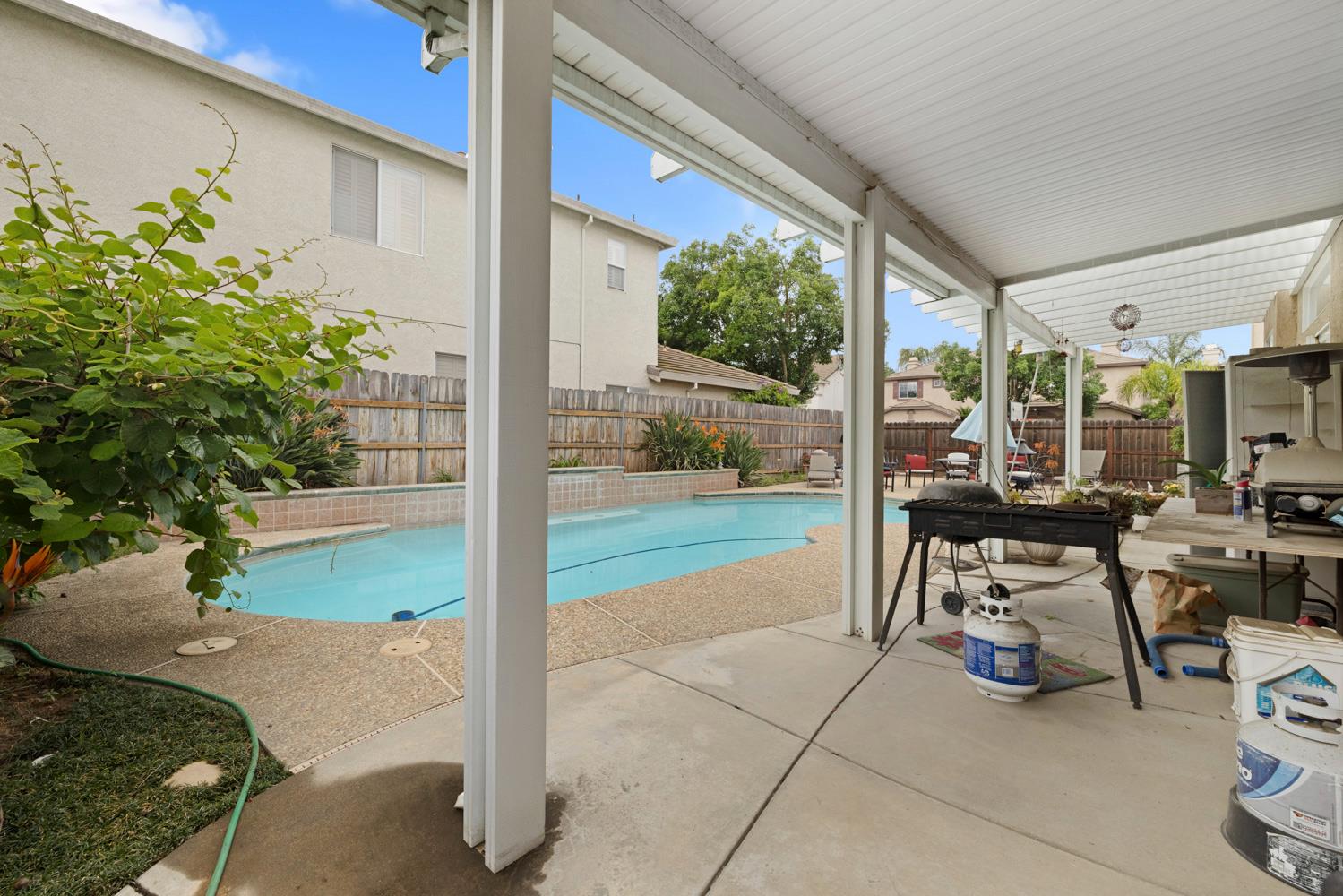 4237 Blake Drive Modesto, CA 95356 - Photo 49 of 49 a view of a patio with table and chairs potted plants with wooden floor and fence