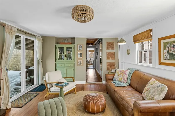 a living room with furniture and a floor to ceiling window