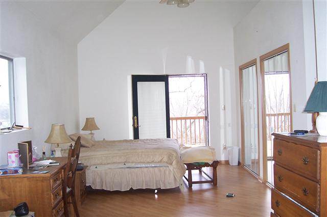 9293 West Diggin Hill Road Hanover, IL 61041 - Photo 17 of 19 a bedroom with a bed and wooden floor