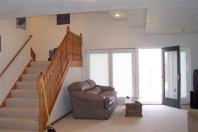 9293 West Diggin Hill Road Hanover, IL 61041 - Photo 18 of 19 a living room with furniture and stairs