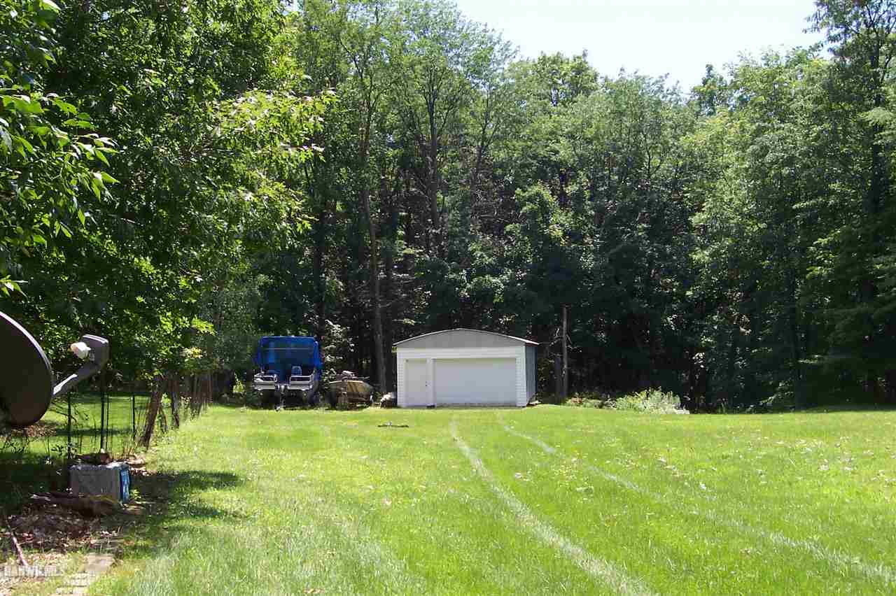 9293 West Diggin Hill Road Hanover, IL 61041 - Photo 6 of 19 a backyard of a house with yard and trampoline